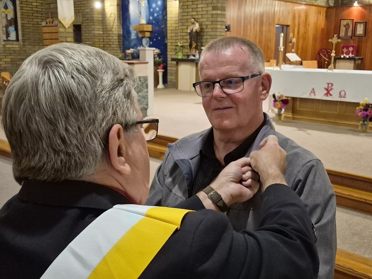 Pinning a new member during the ceremony