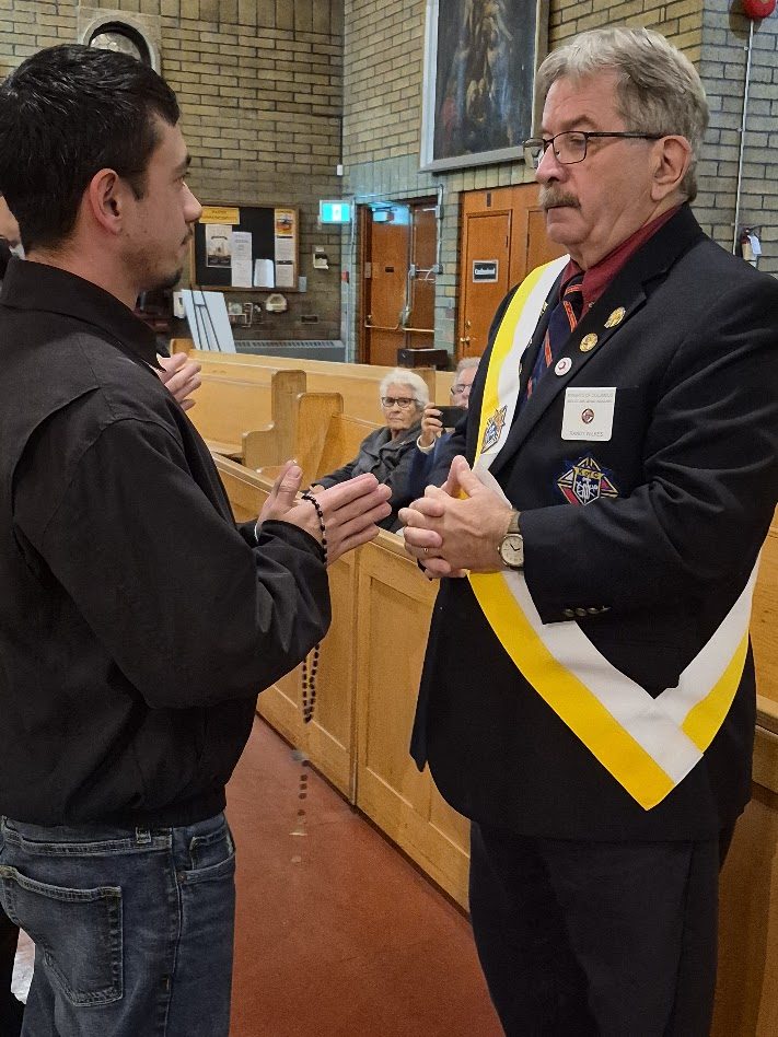 Grand Knight Randy Wilkes welcoming a new candidate