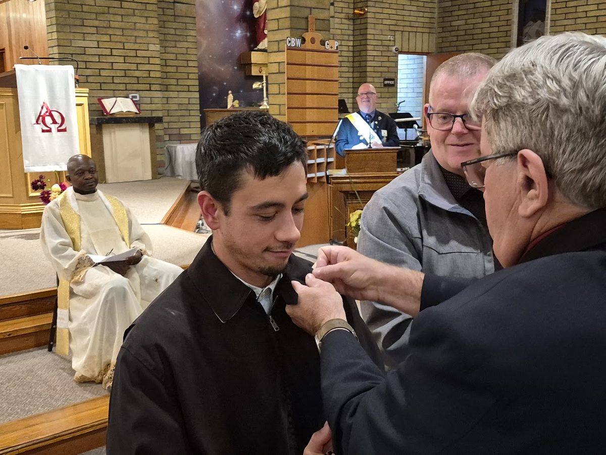 A new Brother Knight receiving his pin at the Exemplification