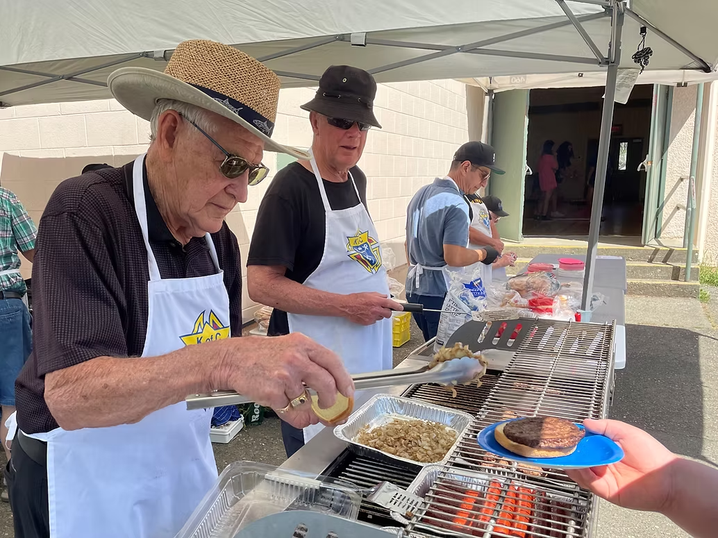 Knights working the grill at Fun Day