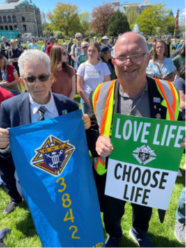 Knights of Columbus members holding Love Life and Choose Life signs at the March for Life
