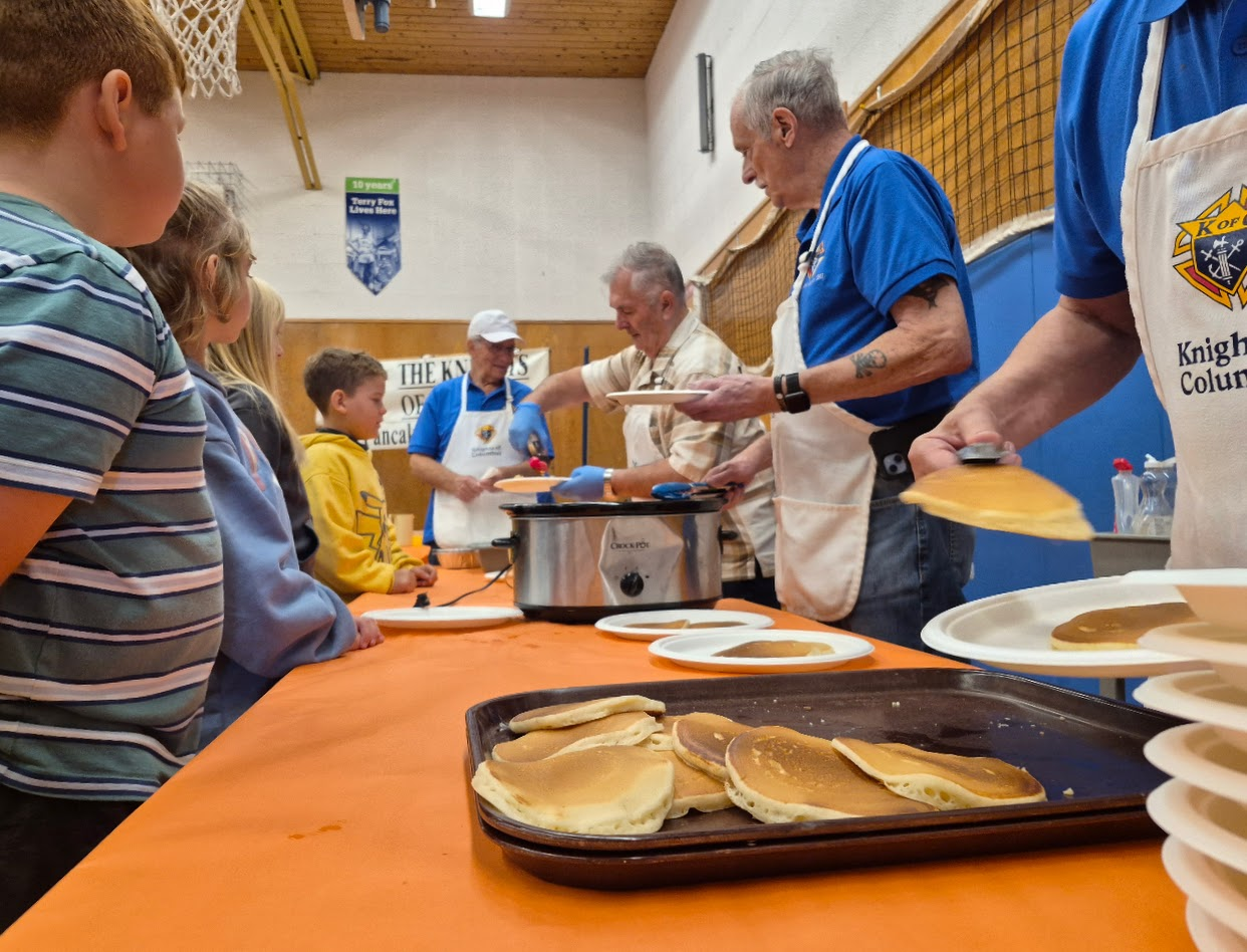 Plating fresh pancakes for students at Rock City School