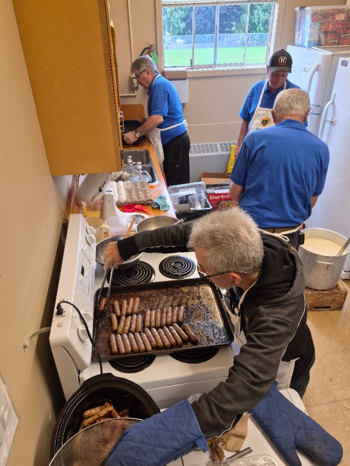 Knights cooking sausages in the Rock City School kitchen