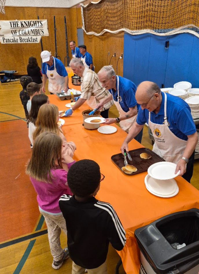 Knights of Columbus Pancake Breakfast banner over the serving line